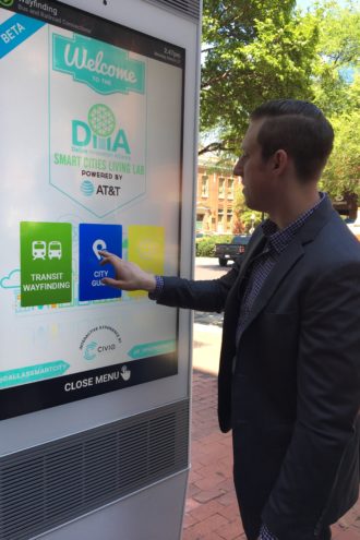 Josh Bergland of CIVIQ Smartscapes demonstrates the West End's new interactive kiosk, which offers visitors, maps, a selfie app, and information on local attractions and services.