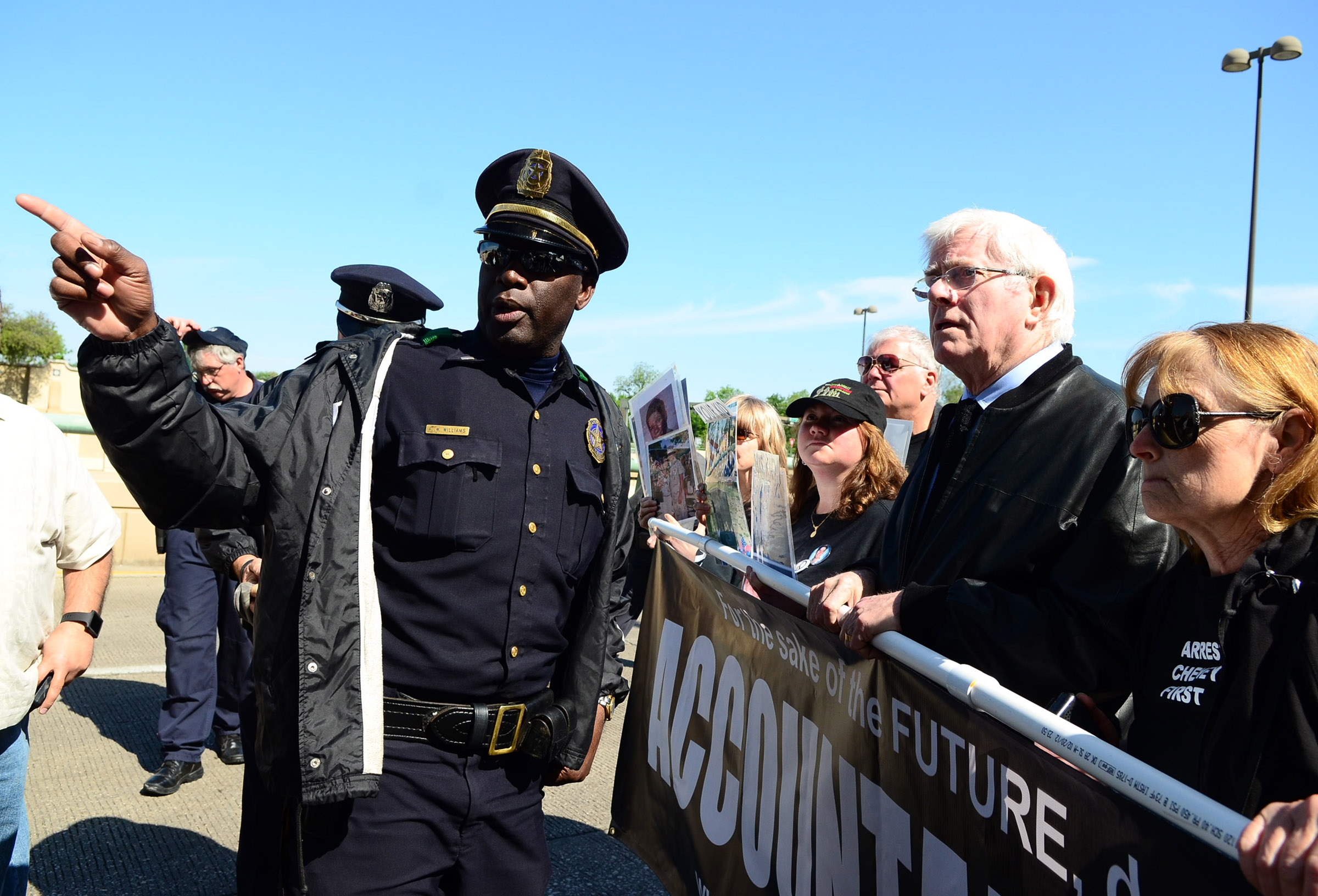 Former TV talk show host Phil Donahue leads a march with other protestors down the North Central Expressway service road.