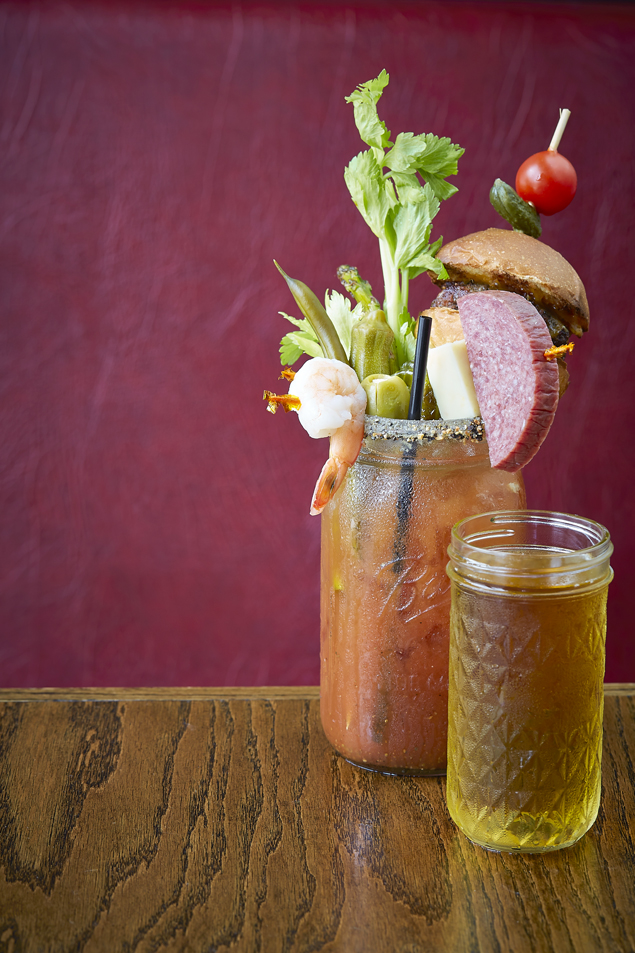 F*** Brunch's Bloody Mary with a cracked peppercorn rim, bacon cheese slider, green bean, sausage, cheese, asparagus, celery, shrimp, tomato, pickle, Brussel sprout, pearl onion, okra, stuffed olive, PBR In A Kerr Jelly Jar (photography by Kevin Marple)