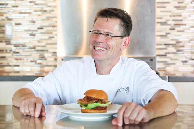 Chef Norman Grimm with a burger