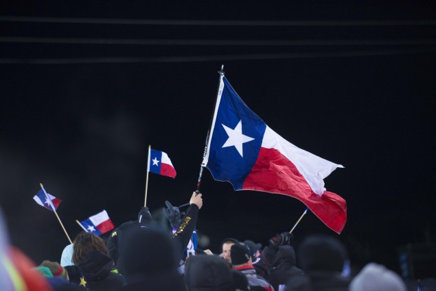 More than 60 friends and family came to watch, Texas flags waving throughout.