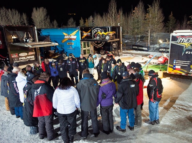 Family prayer circle before Snowmobile Freestyle Finals.