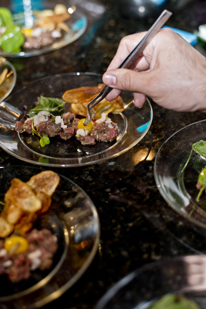 Natera brought his tweezers to garnish the bison tartare. (Photography by Elizabthe Lavin)