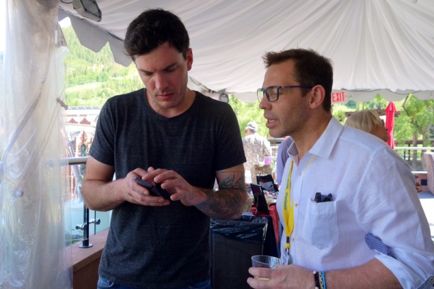 Matt McCallister teaches John Tesar how to make pine tincture from a cell phone app.