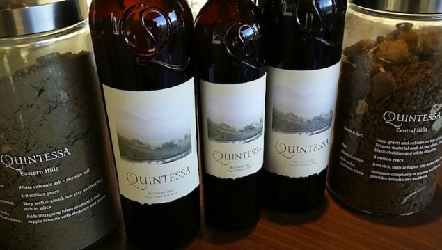 Current release and library vintage Quintessa with soil samples from their property