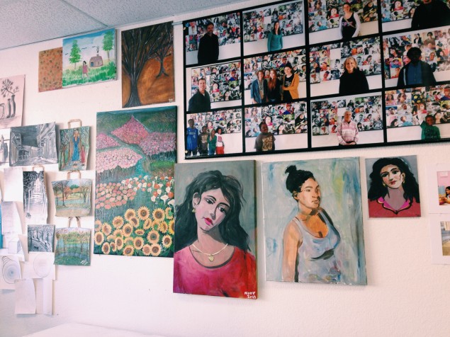 Portraits by Trans.lation artists adorn the walls of the program's storefront space in Vickery Meadows. Photo by Alaena Hostetter.