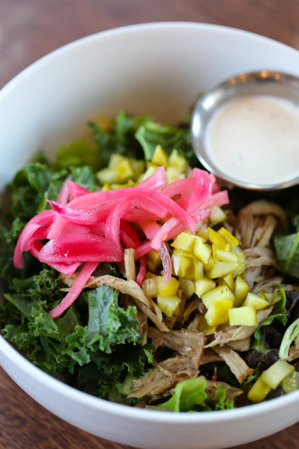 The Deep South: Bourbon-glazed pulled pork, chopped horseradish pickles, shaved kale, pickles red onions, and ranch dressing. 