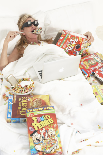 Rachel Hovnanian eating cereal in bed with glasses on. Photo courtesy of the artist.