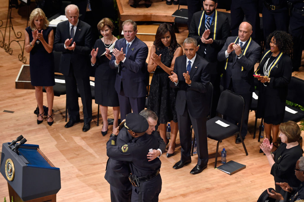 Chief David Brown and Mayor Mike Rawlings embrace at an interfaith memorial service held at the Morton H. Meyerson Symphony Center a few days after the attack.