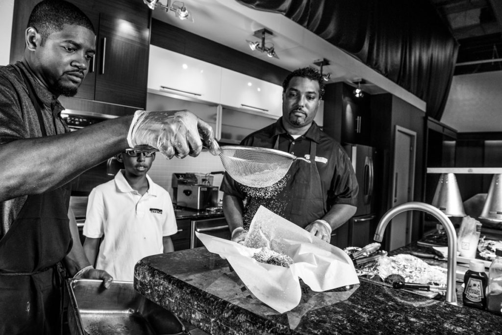 Brent shakes powdered sugar—the standard (and necessary) finishing touch for Big Tex Choice Awards hopefuls—on the Fried Jell-O just before presenting it to the judges.