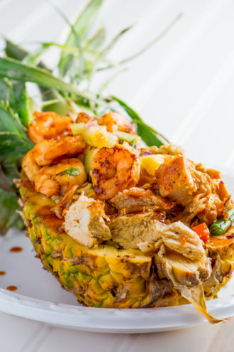 Alade’s creation—marinated grilled chicken and shrimp served over a bed of yellow rice in half of a pineapple—is a rarity in the contest, since it isn’t fried.