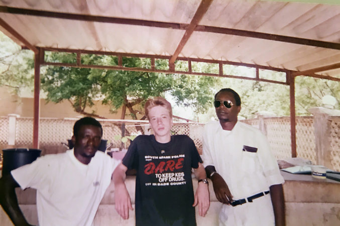 Into Africa: The author with an employee of the house he stayed at in Dar es Salaam (left) and a local “fixer,” someone who could make life in Tanzania easier for a ragtag band of Americans.