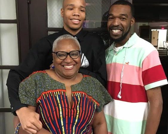 Vicki Meek, who authored the curriculum for Summer Arts At The Center 20 years ago, sits with students Christian Jones, left, and his brother Jonathan Sanders. Photo by Sandra Jones. 
