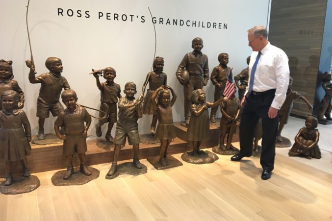 Ross Perot Jr. stands near a statue of his father's 16 grandchildren displayed at the Turtle Creek campus.