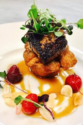 Seared Hudson Valley foie gras with cinnamon monkey bread, hickory-smoked butterscotch, almonds and cherries.