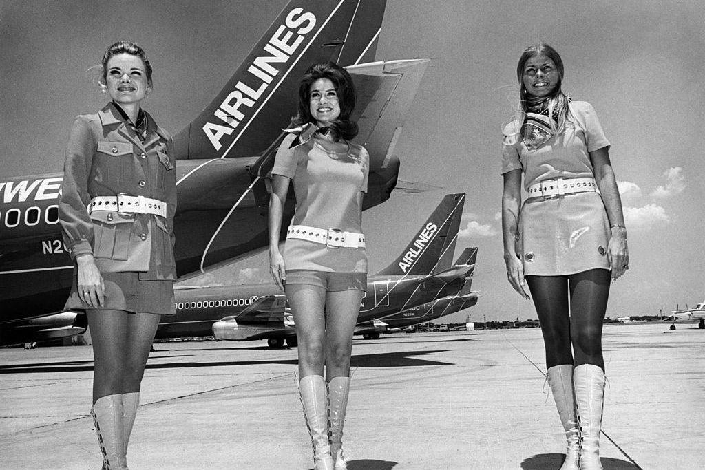 In the late 1960s, flight attendants—known as “stewardesses” then—wore go-go boots, hot pants, and miniskirts. 