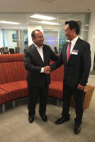 Marcos Jimenez, CEO of Softtek's U.S. and Canada operations, shakes the hand of newly elected Addison Mayor Joe Chow.