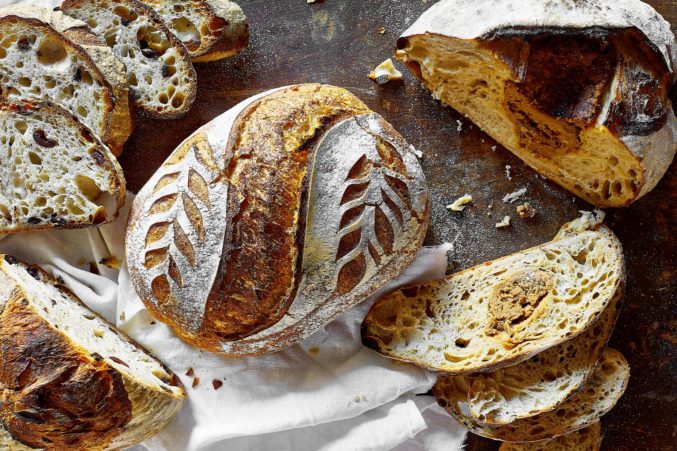 A loaf of sourdough bread with a leaf-style pattern.