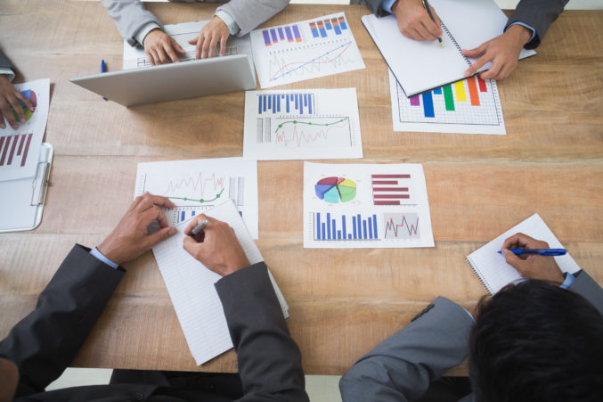 Business people in board room meeting studying some graphics