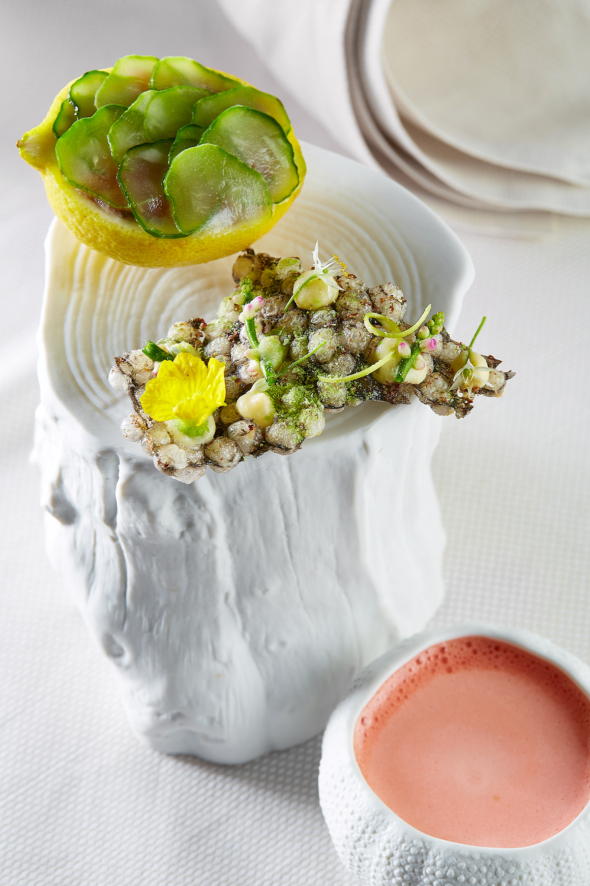 amuse bouche with a squid-ink chip and a fizzy watermelon-shiso