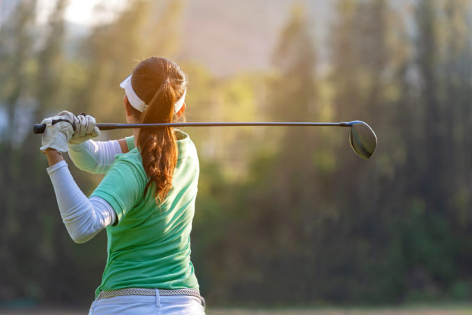 woman playing golf in tournament