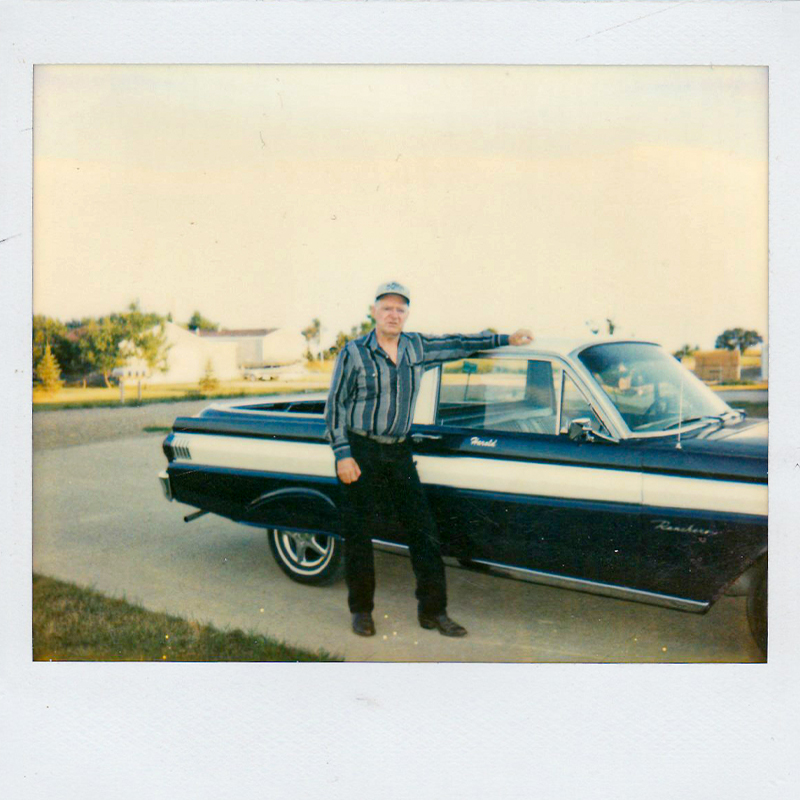 Harold Henry standing next to his car