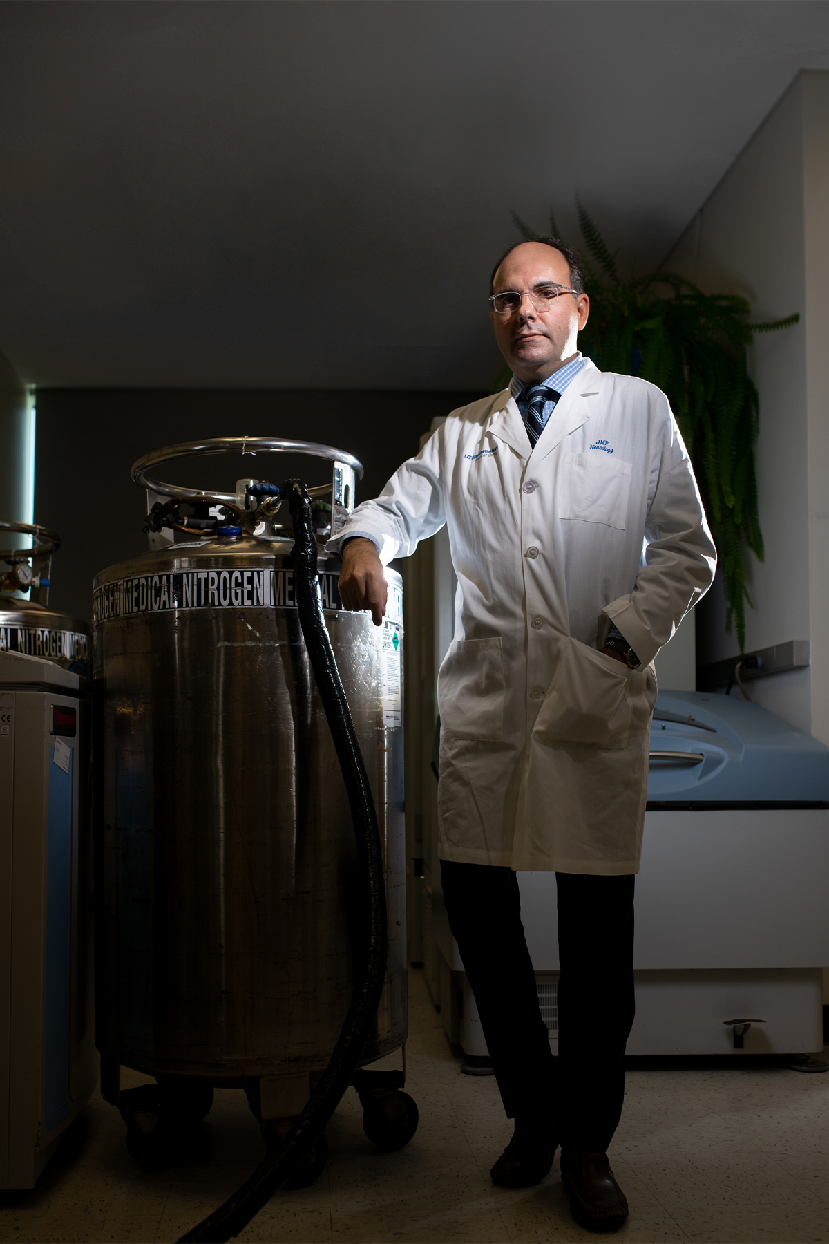 Dr. Pascual standing next to a nitrogen tank