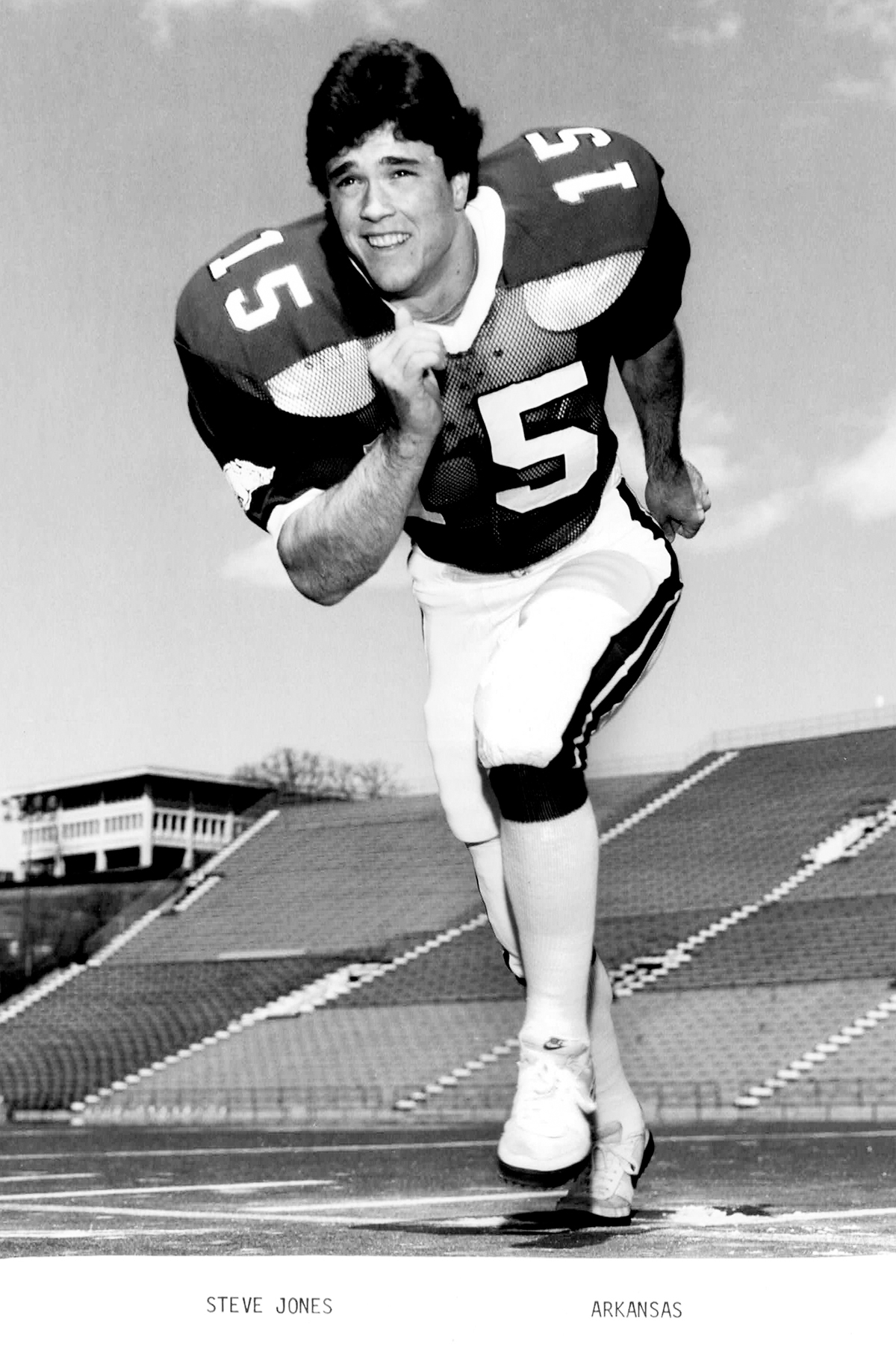 Running posed portrait of Stephen in his Arkansas football uniform