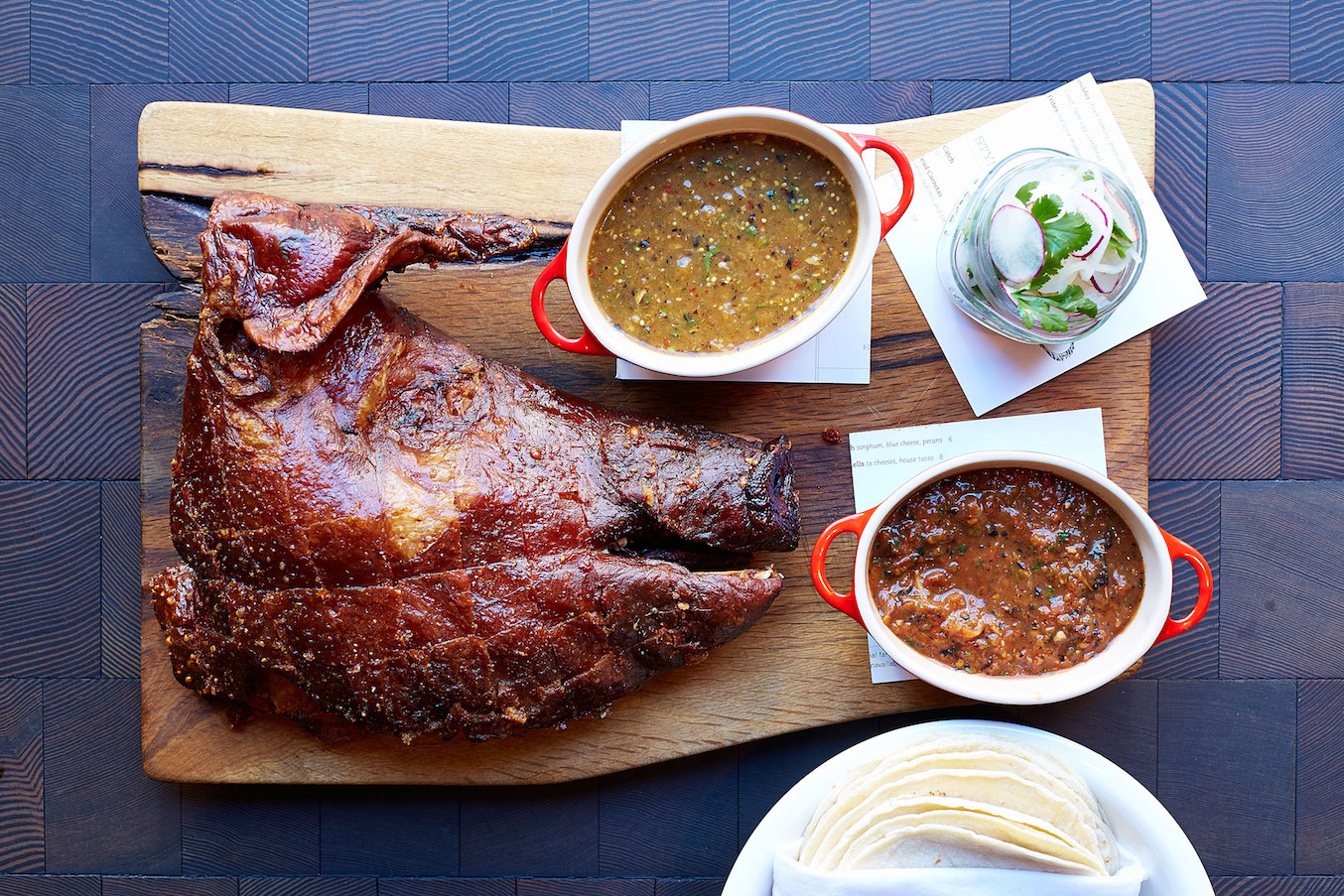 A wood platter with a huge portion of crisp, cook heritage pork from CBD Provisions restaurant.