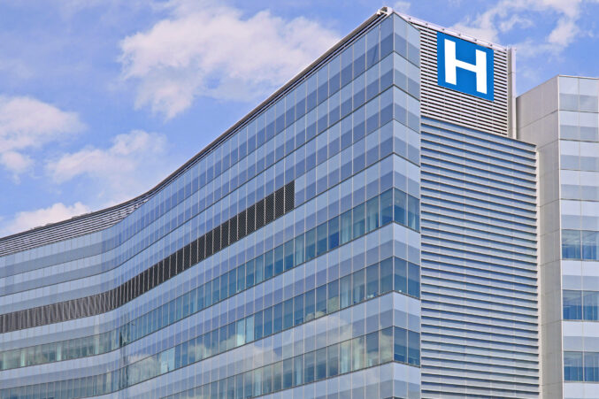 Building with large H sign for hospital iStock