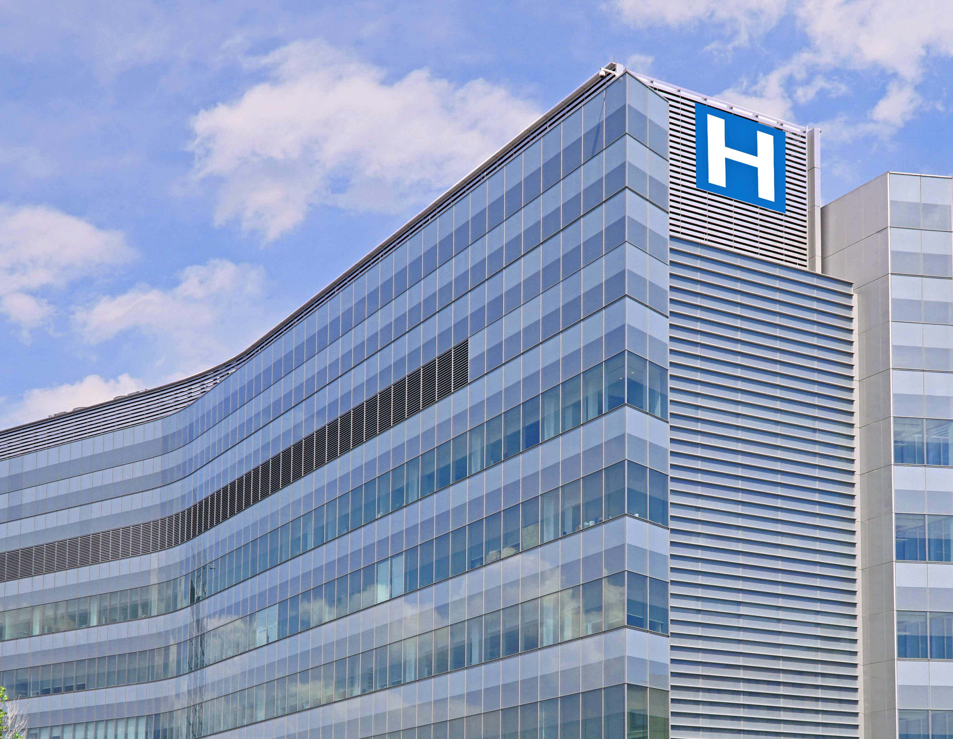 Building with large H sign for hospital iStock