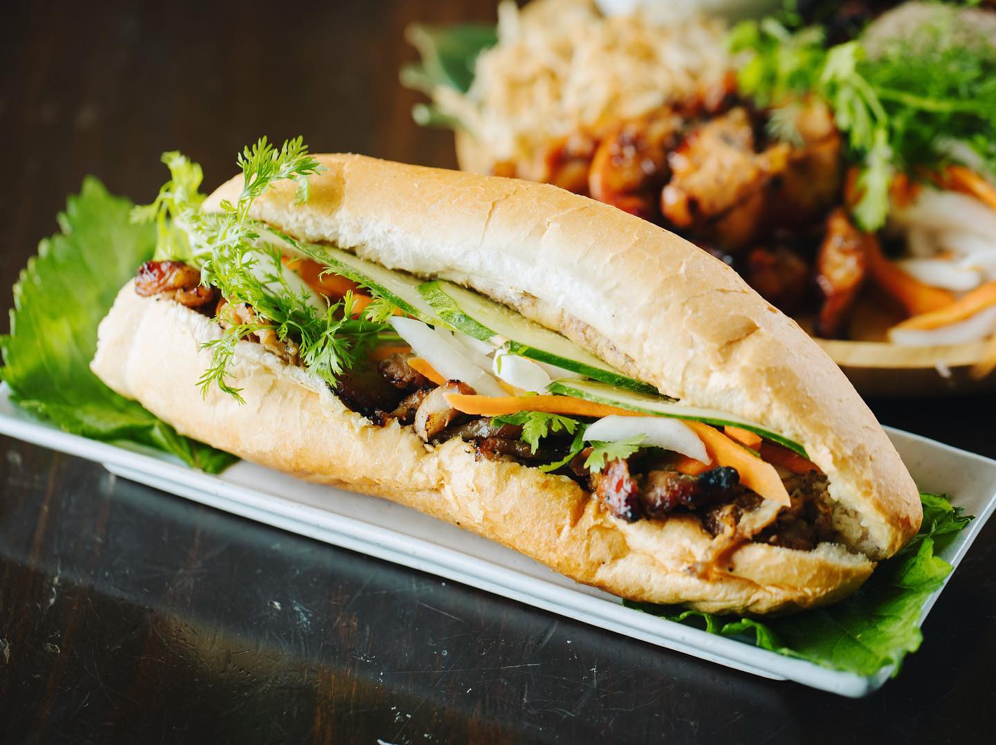 A Vietnamese sandwich, called banh mi, on a plate.