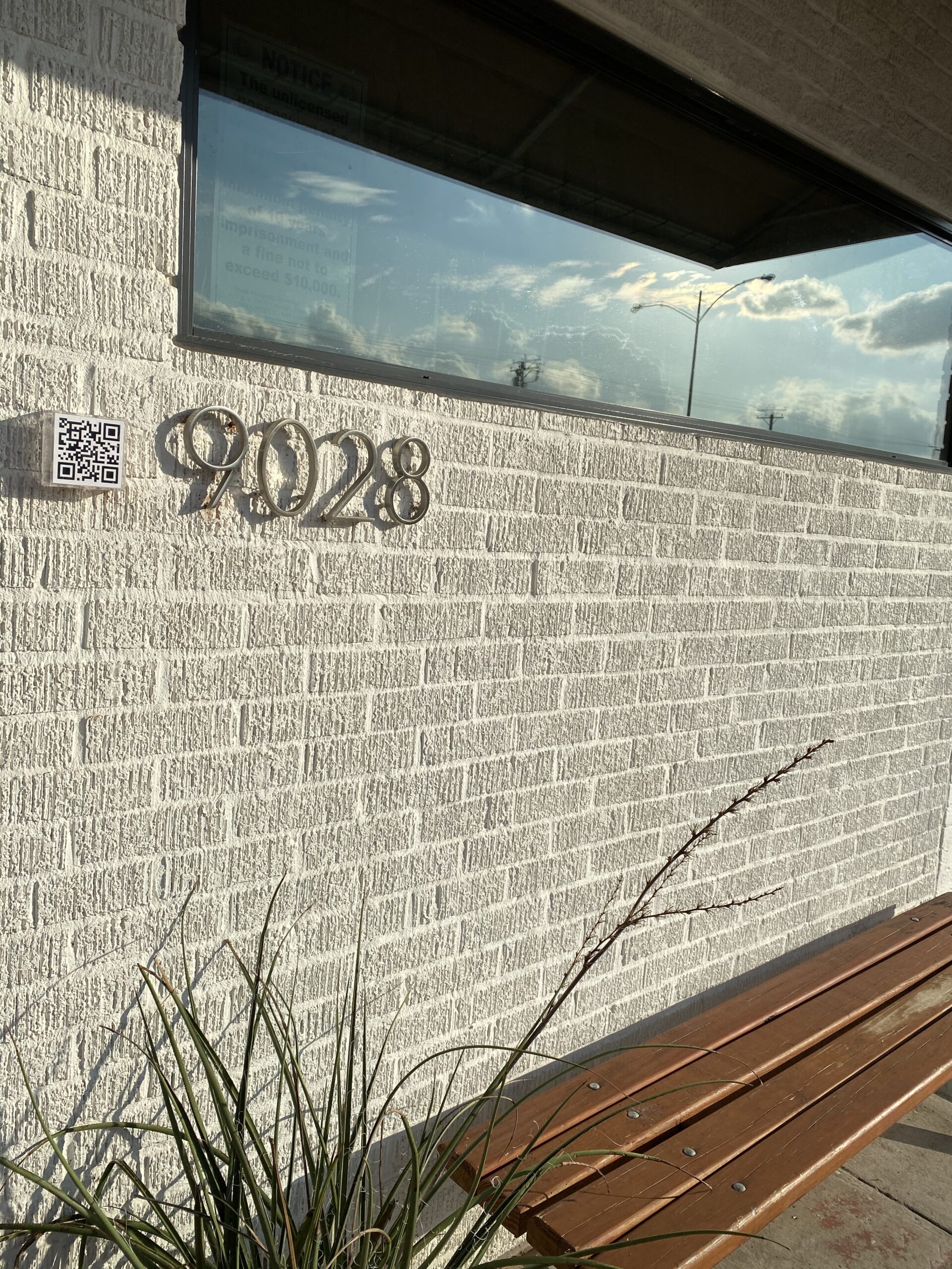 Exterior entrance of Lounge Here restaurant in East Dallas, with new QR code.