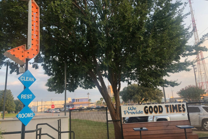 An arrow sign that says "clean restrooms," and another that reads, "we provide good times."