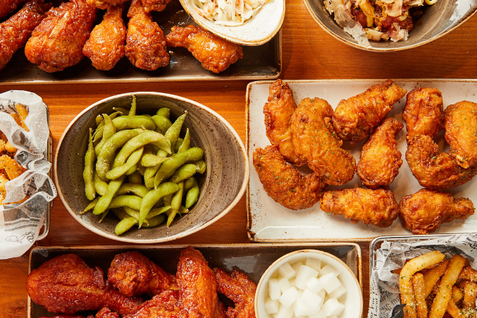 A platter of edamame, Korean fried chicken, and other bites.
