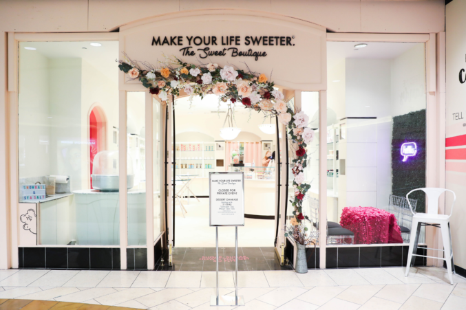 Make Your Life Sweeter The Sweet Boutique's paper flower entrance at the Dallas Galleria.