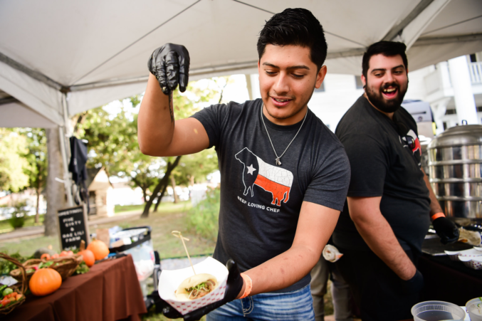 A chef seasoning a bite from a previous year's Chefs for Farmers food festiival