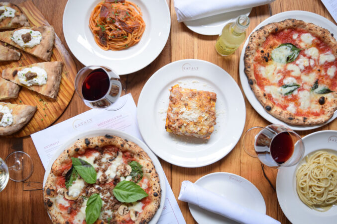 A table of pizza and pasta.