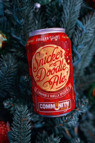 A Snickerdoodle Ale with a pine tree background