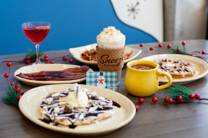 A table with pancakes, Christmas cocoas, and more.