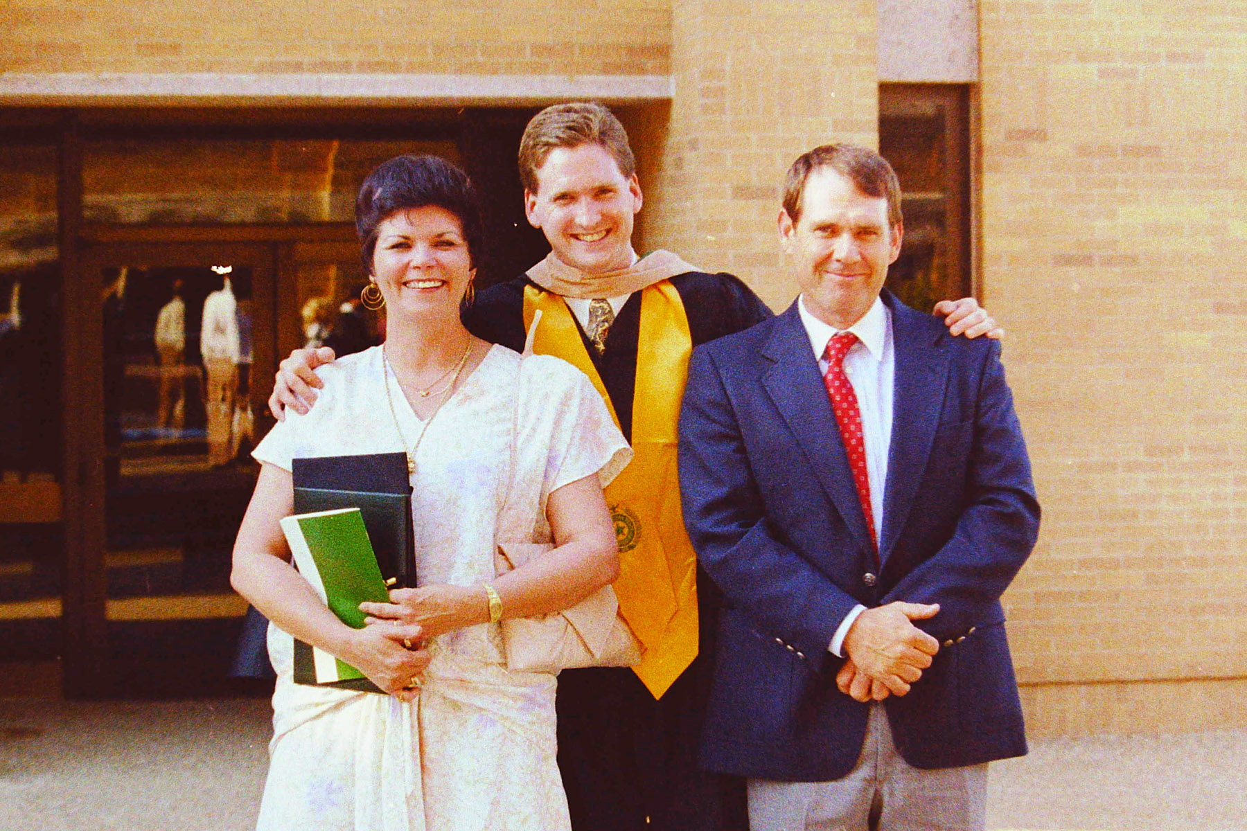 Brint Ryan with parents at college graduation
