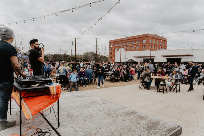 A huge crowd of people standing outside eating and drinking at Four Corners Brewing Co. for the Dallas Filipino Food Festival in 2020