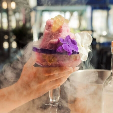 A hand holding a frozen (via liquid nitrogen) margarita.