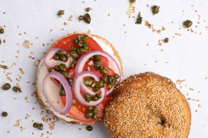 A sesame bagel lox sandwich with smoked salmon, red onion, capers, and schmear from Lenore's Handmade Bagels.