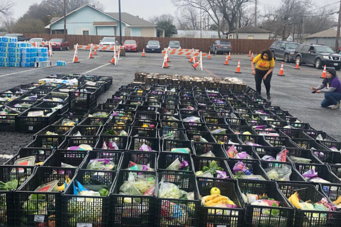 D2 Candidate Jennifer Cortez (left, in yellow) and Danaë Gutiérrez at a food distribution in Far East Dallas in February, shortly after the winter storms.