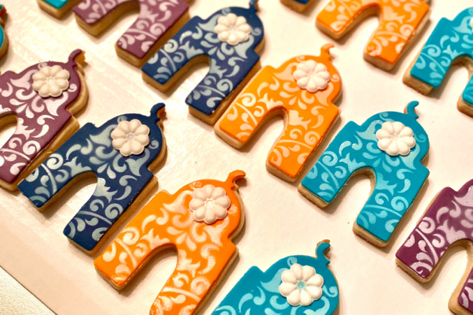 Mosque-shaped cookies in orange and teal, made by Plano-based homebaker Saadia Iqbal for Eid.