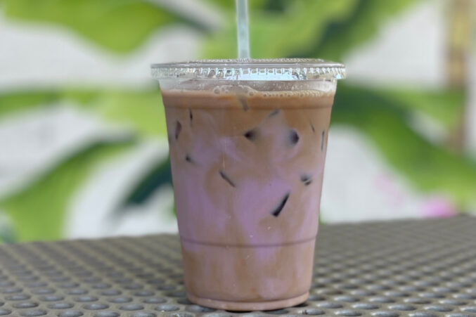 In a plastic cup: Vietnamese coffee with pink-hued hibiscus