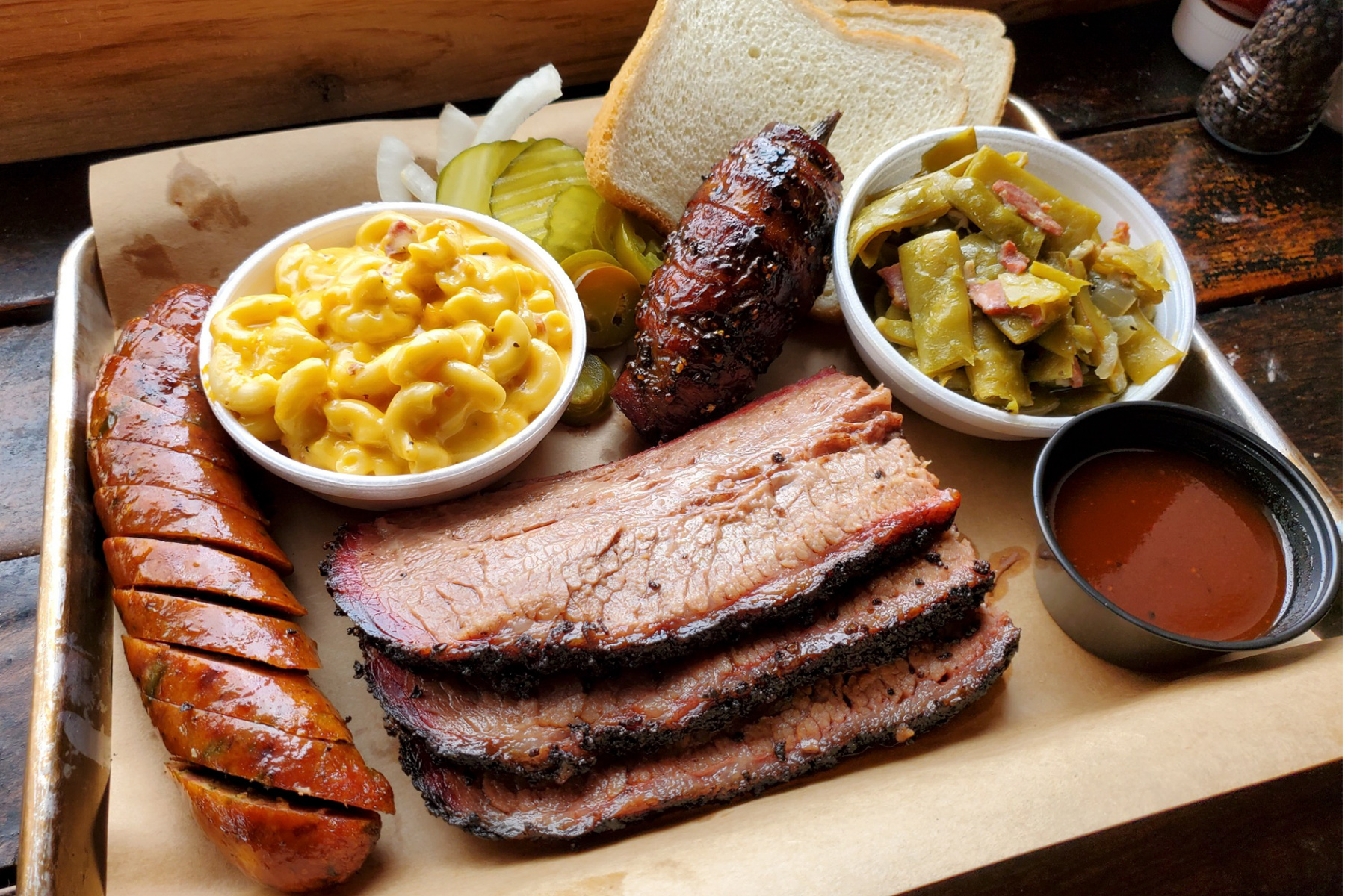 Picture of a barbecue tray from Hutchins BBQ, including a bacon-wrapped jalapeño pepper.
