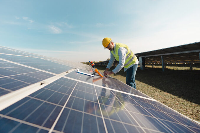 man working on solar panels