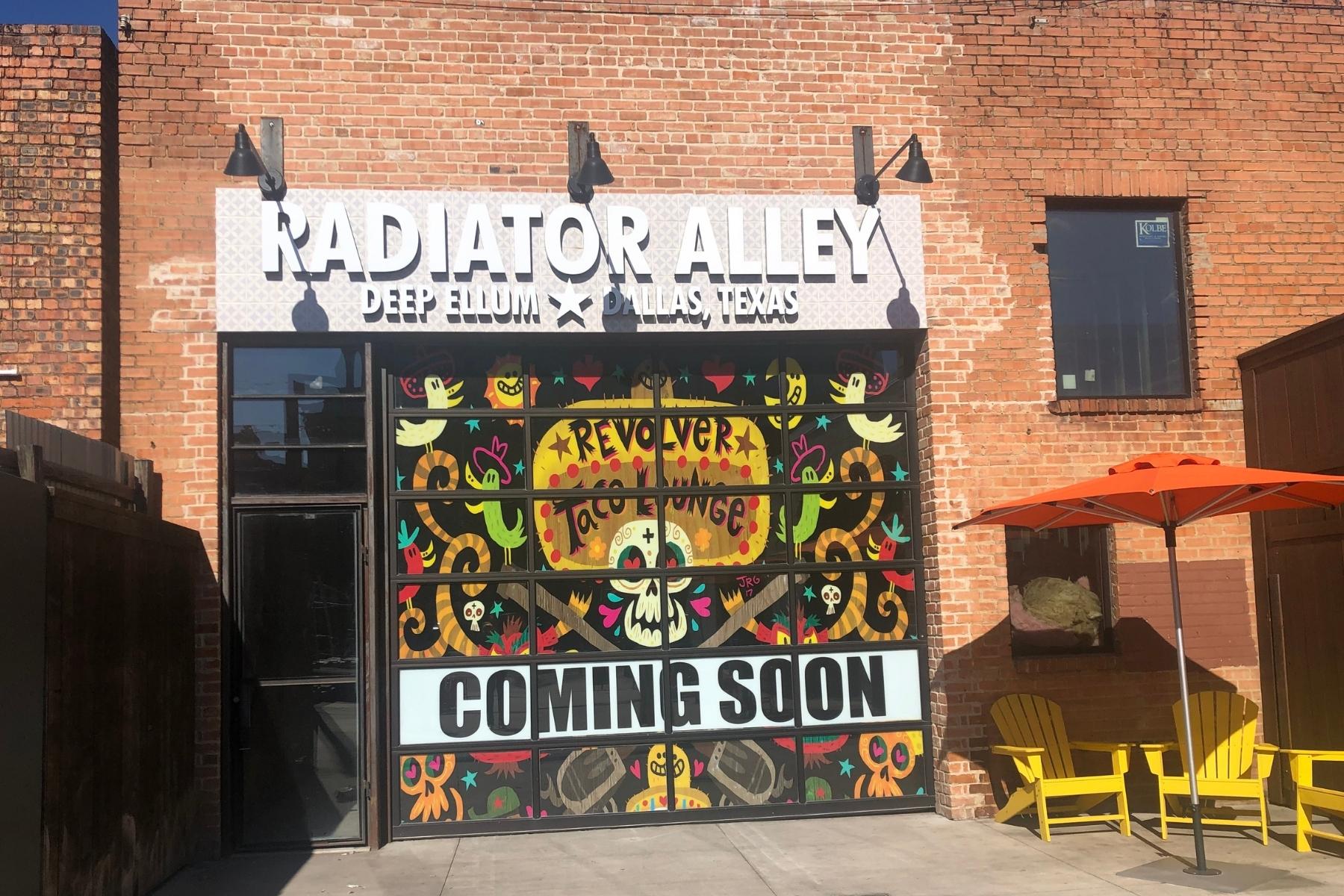 A “Coming Soon” sign for Revolver Taco Lounge in the Radiator Alley part of Deep Ellum in between Main and Elm streets.